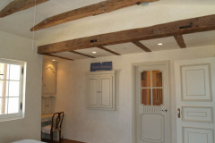 Shady Canyon - Reclaimed beam ceiling in bedroom