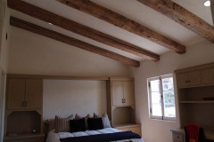 Shady Canyon - Reclaimed beam ceiling in bedroom